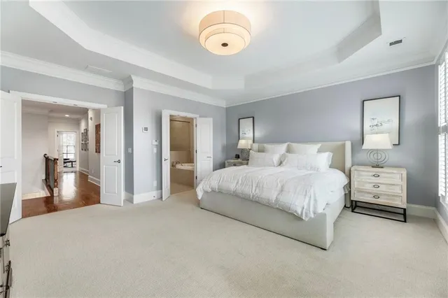 a bedroom with a bed and a large mirror