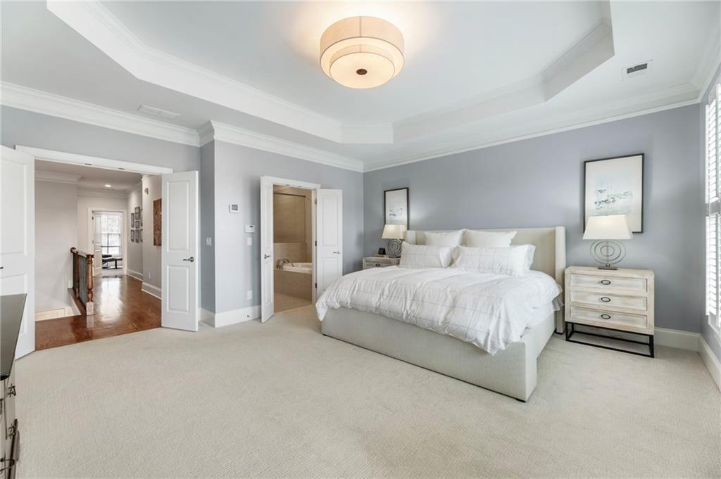 3611 Habersham Road Northwest Atlanta, GA 30305 - Photo 26 of 44 a bedroom with a bed and a large mirror