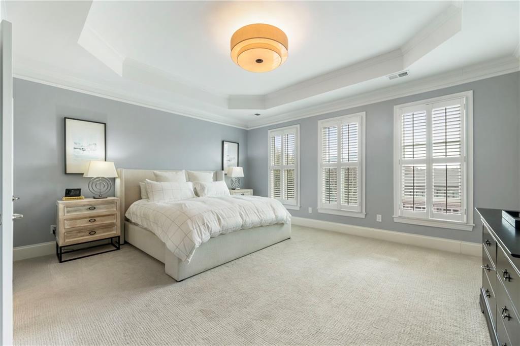 3611 Habersham Road Northwest Atlanta, GA 30305 - Photo 27 of 44 a spacious bedroom with a bed and a large window