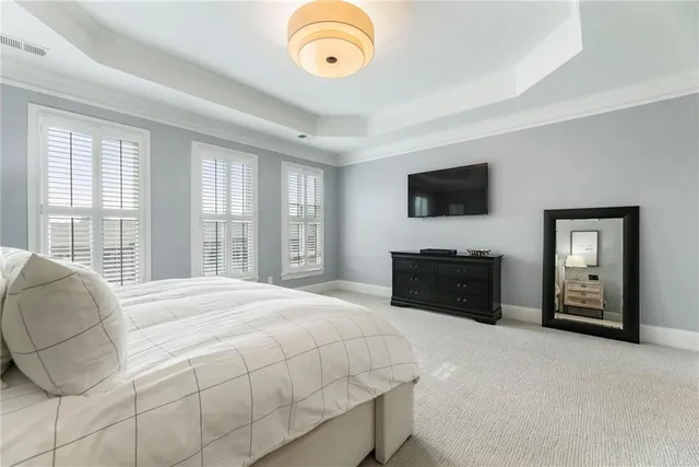 a bedroom with a bed and a television