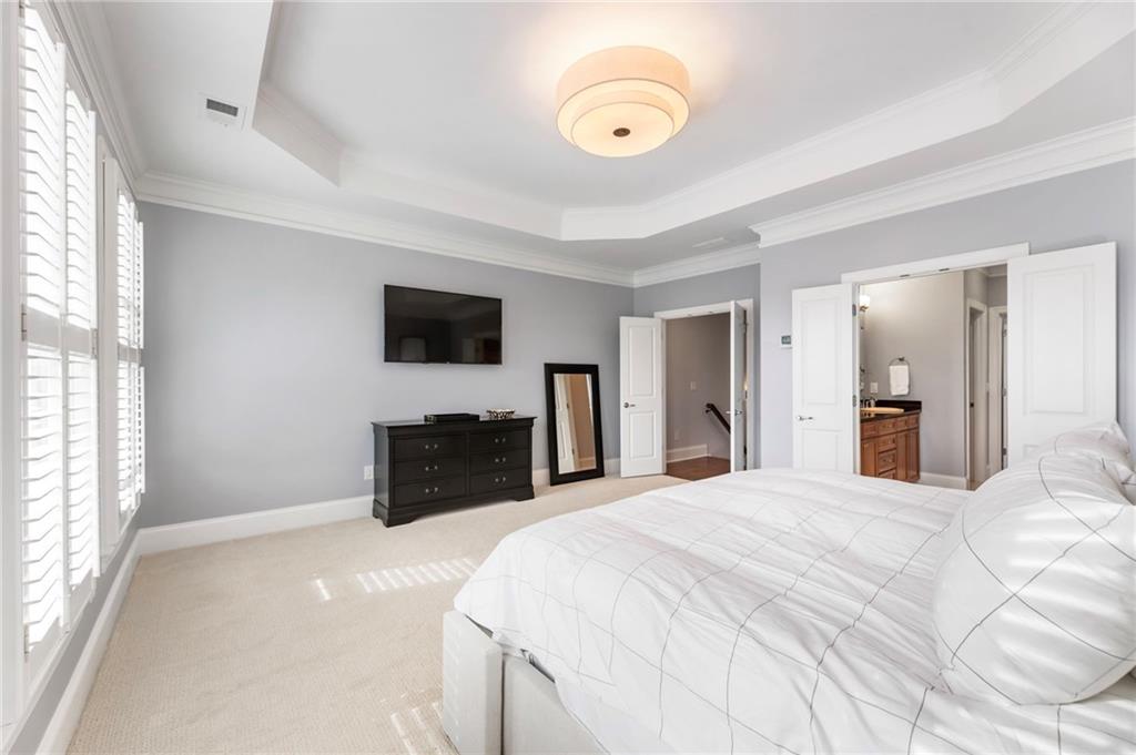 3611 Habersham Road Northwest Atlanta, GA 30305 - Photo 30 of 44 a bedroom with a bed and a flat screen tv