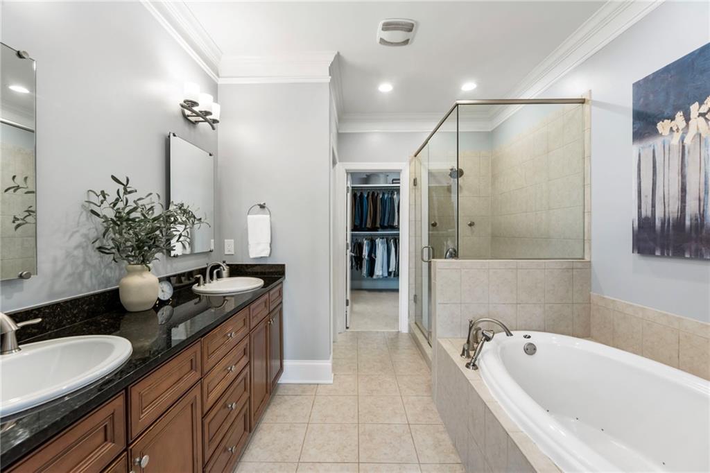 3611 Habersham Road Northwest Atlanta, GA 30305 - Photo 34 of 44 a spacious bathroom with a granite countertop tub sink and mirror
