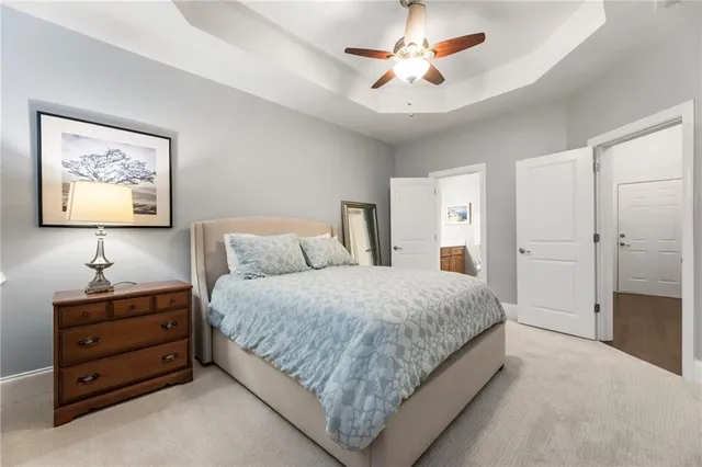 a spacious bedroom with a bed and a chandelier