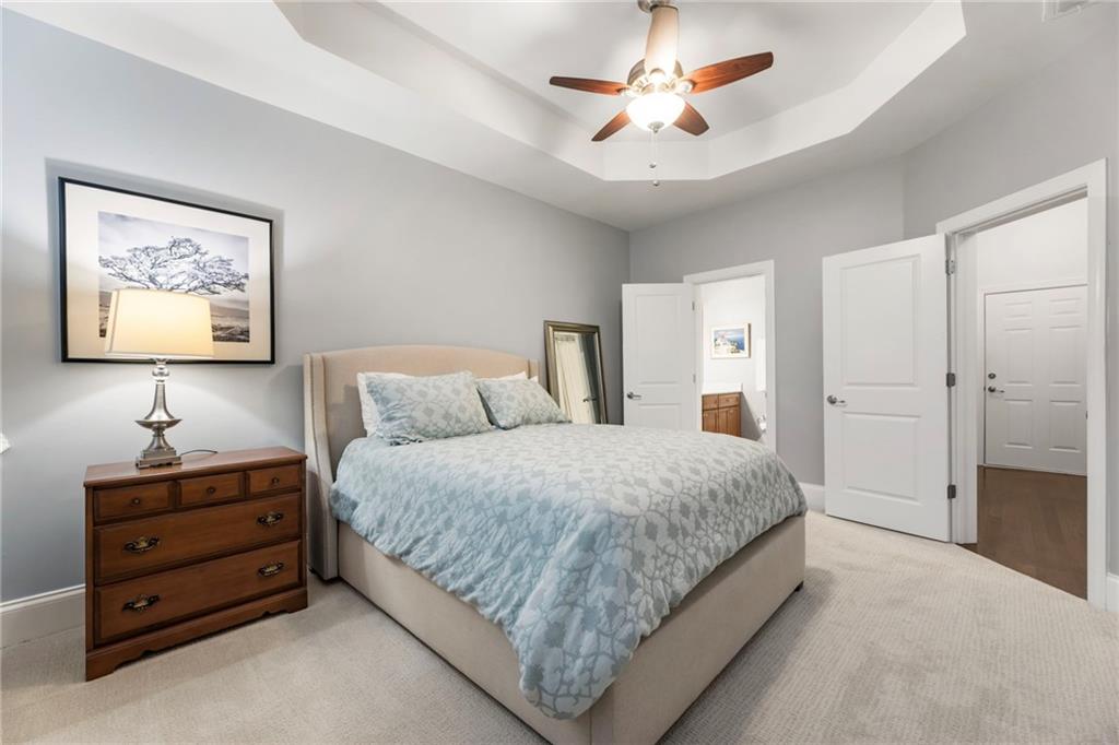 3611 Habersham Road Northwest Atlanta, GA 30305 - Photo 39 of 44 a spacious bedroom with a bed and a chandelier