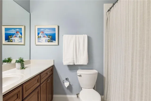 a bathroom with a toilet sink and vanity