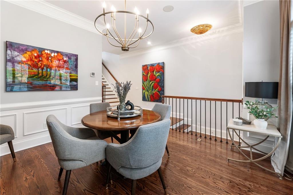 3611 Habersham Road Northwest Atlanta, GA 30305 - Photo 7 of 44 a dining room with furniture a chandelier and wooden floor