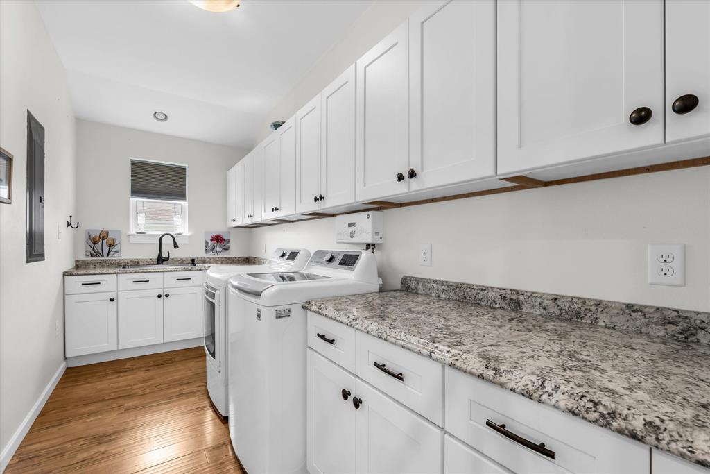 348 Barker Lane Waco, TX 76705 - Photo 6 of 39 a kitchen with granite countertop white cabinets and white appliances