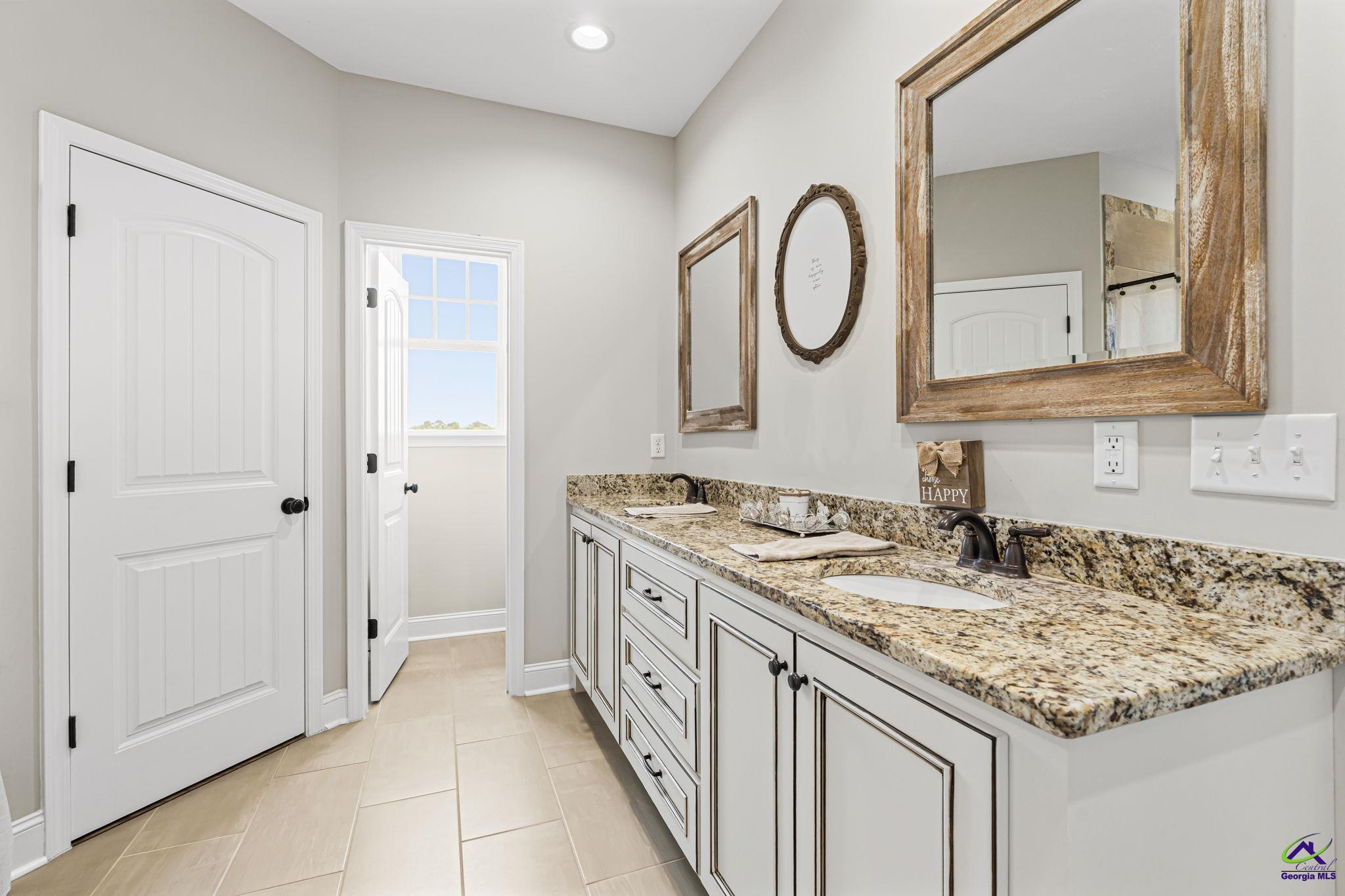 180 Woodland Trail Road Cochran, GA 31014 - Photo 15 of 25 a bathroom with a granite countertop sink and a mirror