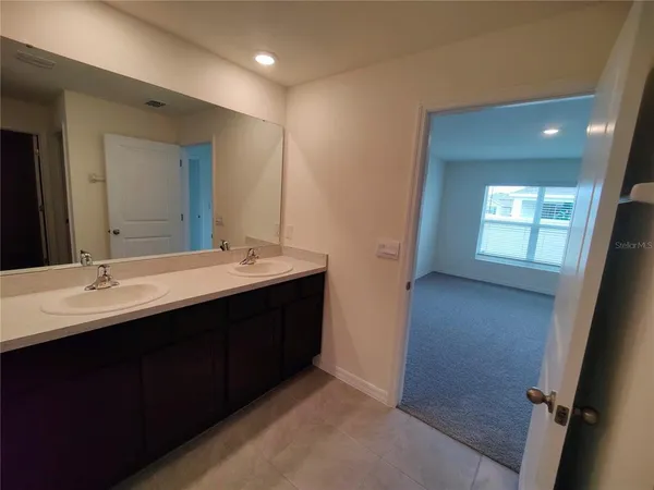 a bathroom with a double vanity sink a and mirror