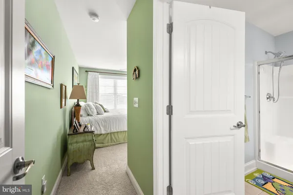 a bedroom with a bed dresser and a window