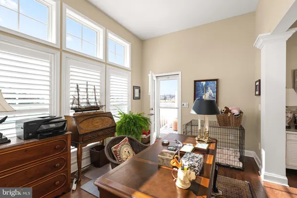 a living room with furniture and floor to ceiling windows