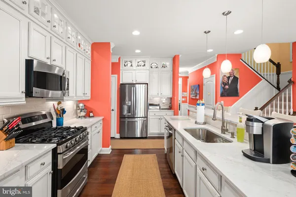 a dining room with furniture a chandelier and wooden floor