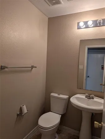 a bathroom with a sink a toilet and mirror