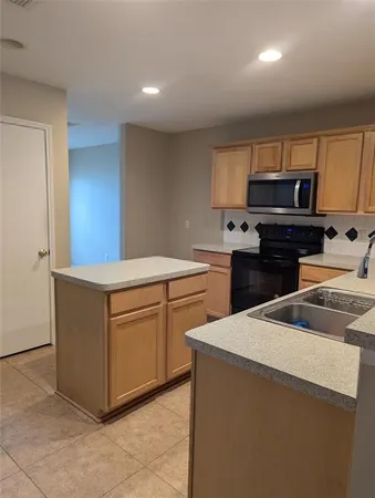 a kitchen with a cabinets and white appliances
