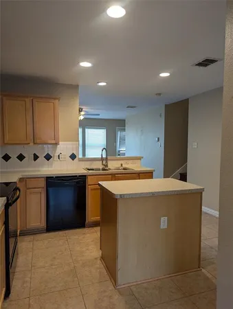 a kitchen with granite countertop a sink and a stove
