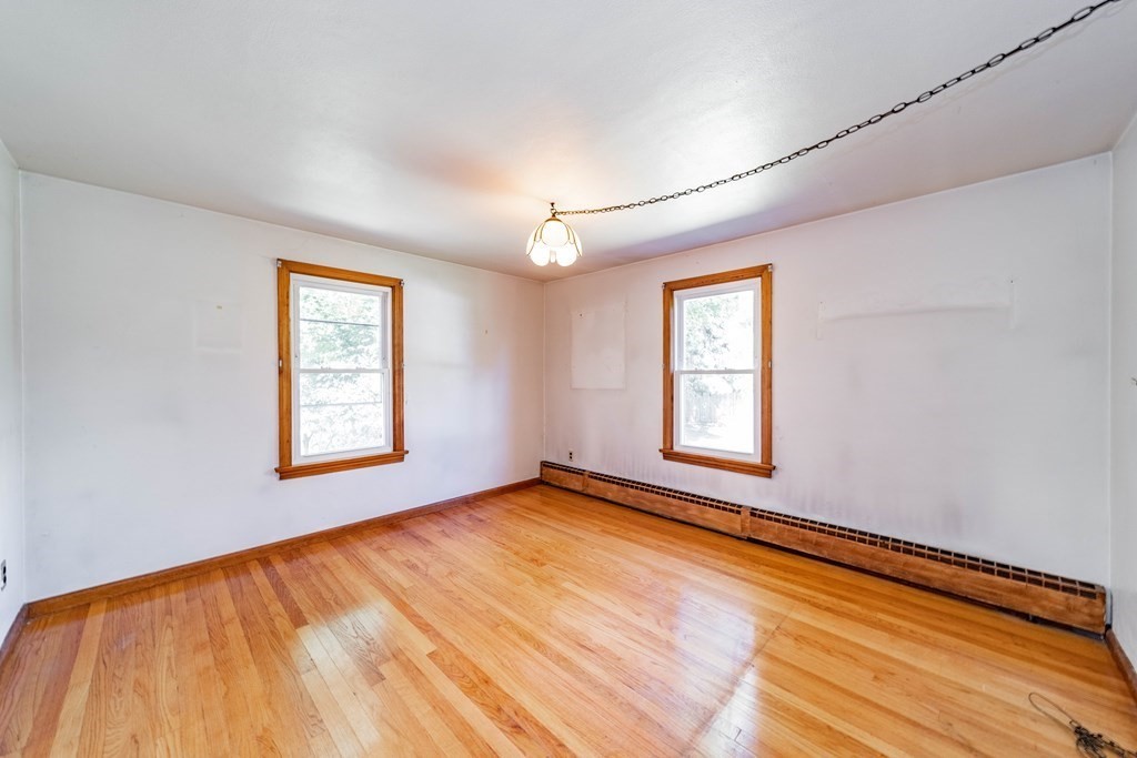 61 Davis Street Springfield, MA 01104 - Photo 15 of 28 a view of an empty room with window and wooden floor