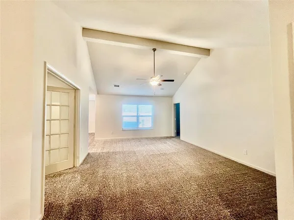 an empty room with windows and closet