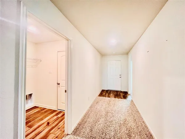 a view of a bedroom with wooden floor and bed