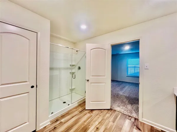 a view of empty room with wooden floor and cabinet