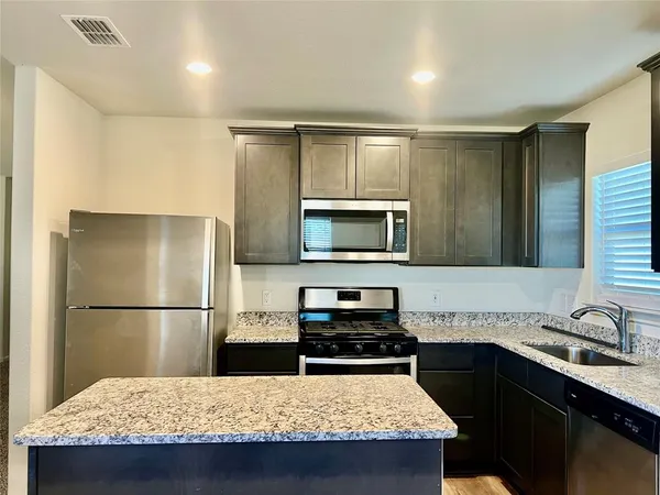 a kitchen with a stove and a microwave
