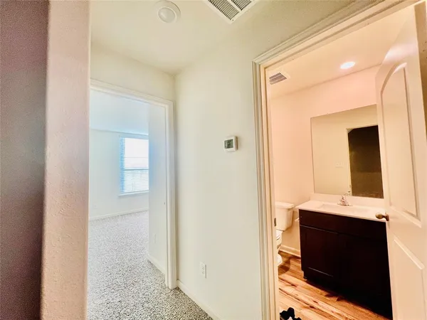 a view of bathroom with mirror toilet and bathroom