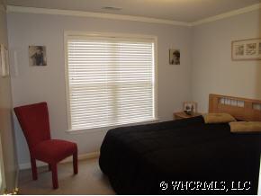 249 Planters Creek Road Fletcher, NC 28732 - Photo 11 of 12 a bedroom with a bed and a chair