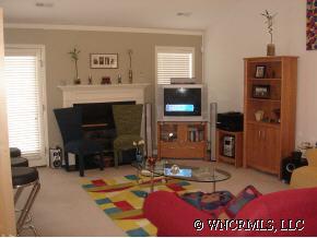 249 Planters Creek Road Fletcher, NC 28732 - Photo 4 of 12 a living room with furniture a flat screen tv and a fireplace