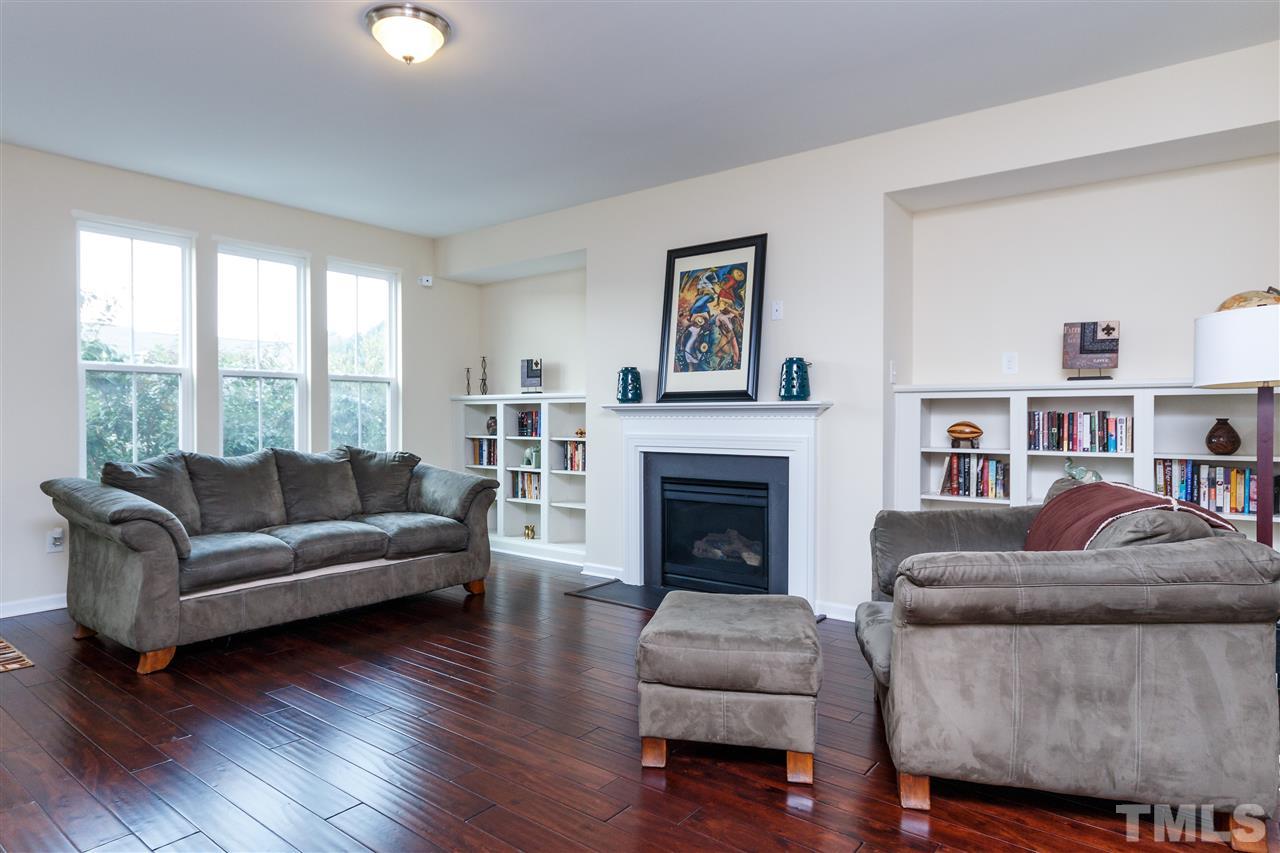 1305 Rodessa Run Raleigh, NC 27607 - Photo 7 of 25 Enjoy the spacious living room with built in book shelves, and hardwoods throughout the second floor!