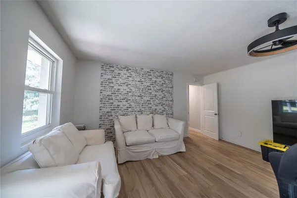 a view of a livingroom with furniture and a window