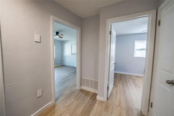 a front view of a house with a garden and trees