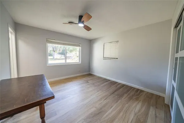 a front view of a house with a garden and trees