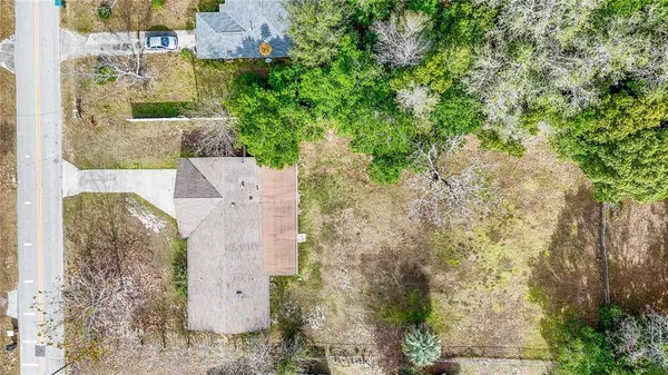 an aerial view of a house with yard and outdoor seating