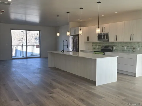 a view of kitchen and wooden floor