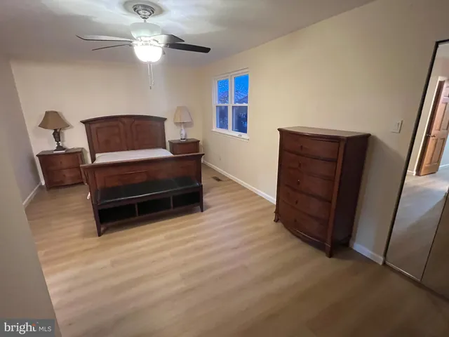 a living room with furniture and a dresser