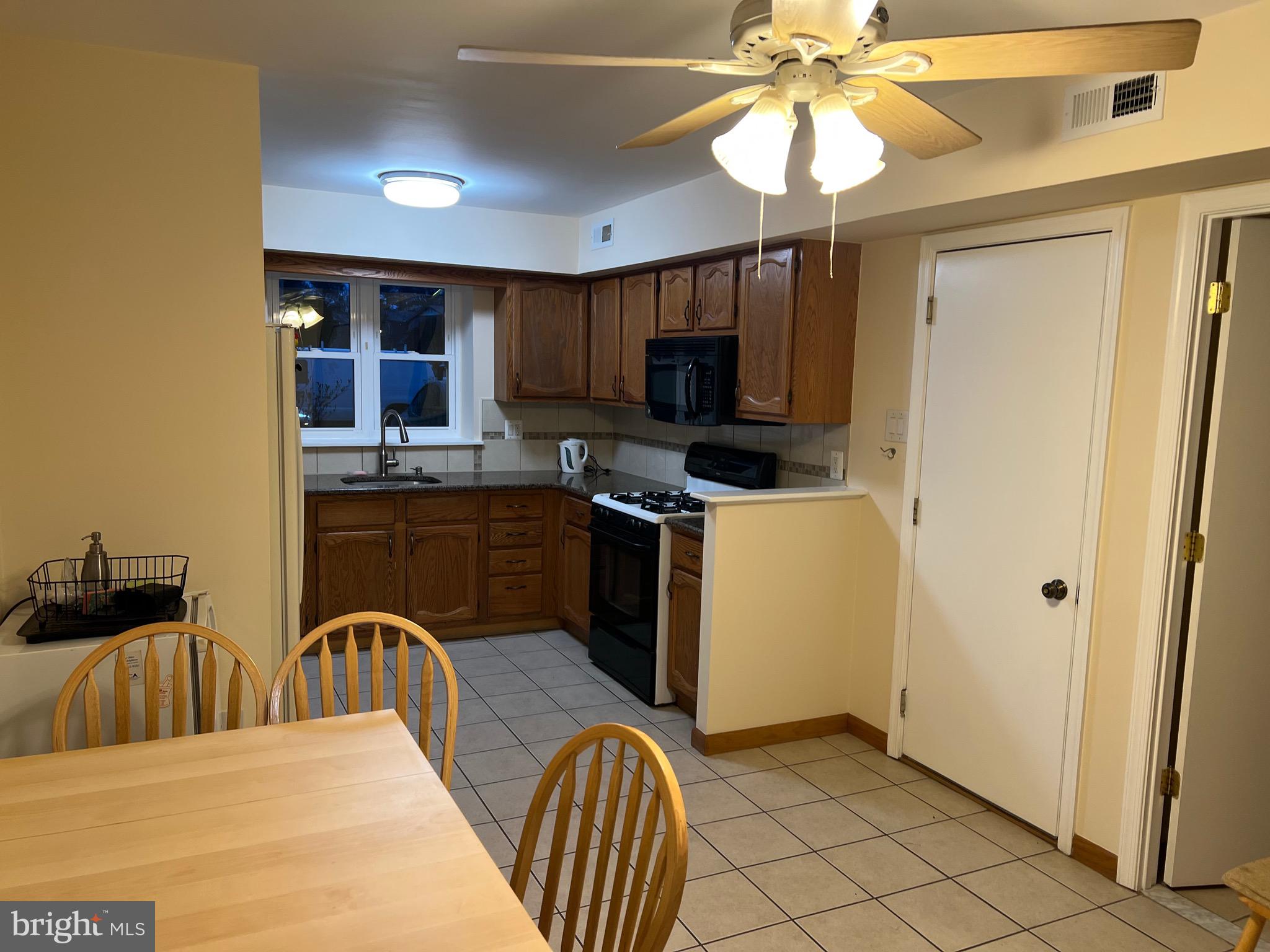 10202 Murty Lane Philadelphia, PA 19116 - Photo 8 of 8 a kitchen with stainless steel appliances granite countertop a stove a sink dishwasher and a refrigerator