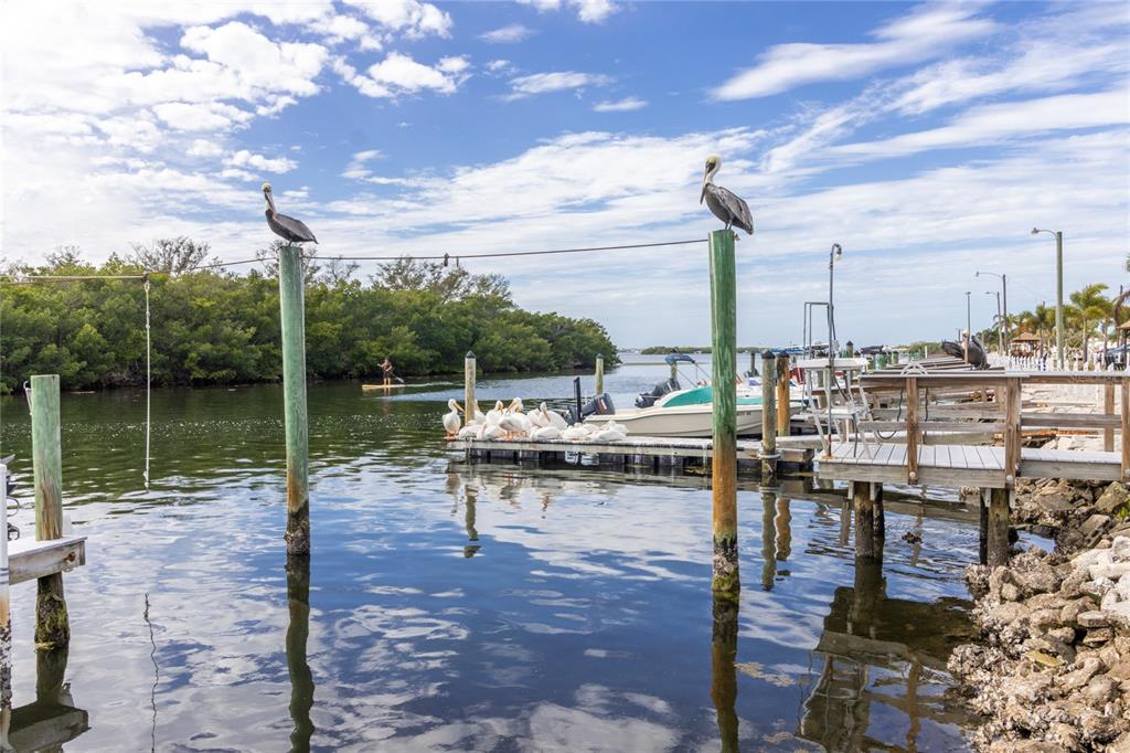 a view of a lake with table and chairs