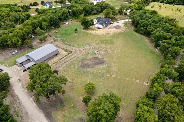 an aerial view of a residential houses with outdoor space