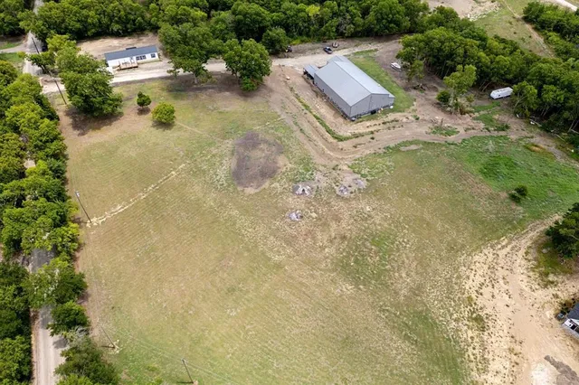 an aerial view of residential house with pool and yard