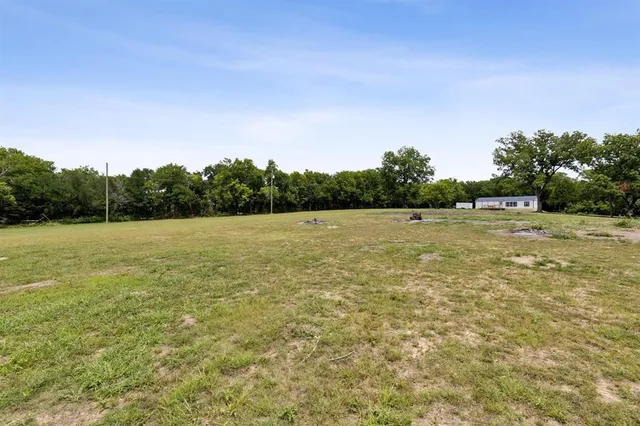 a view of a field with an ocean view