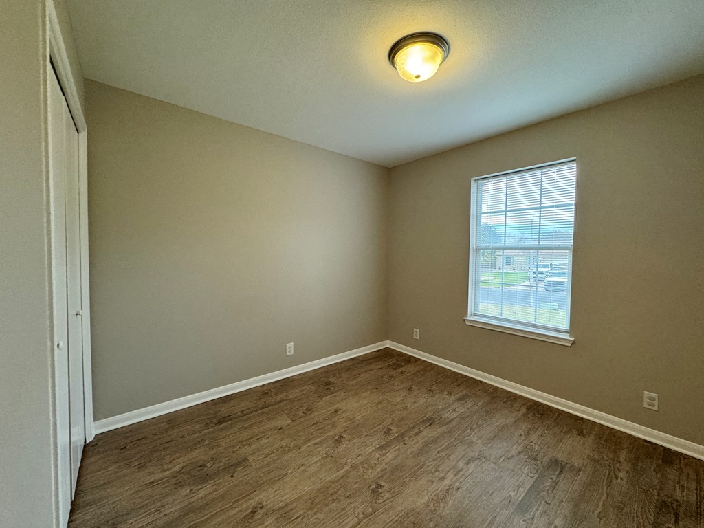 219 Crystal Knoll Boulevard Georgetown, TX 78626 - Photo 16 of 32 an empty room with wooden floor and windows