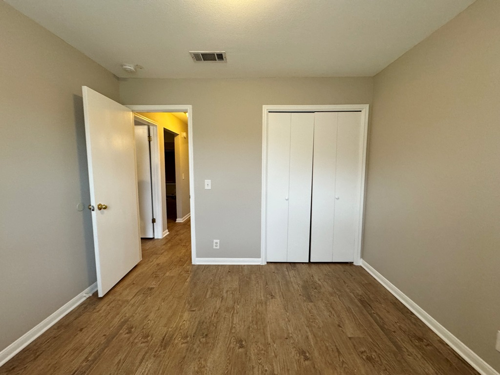 219 Crystal Knoll Boulevard Georgetown, TX 78626 - Photo 18 of 32 an empty room with wooden floor and door