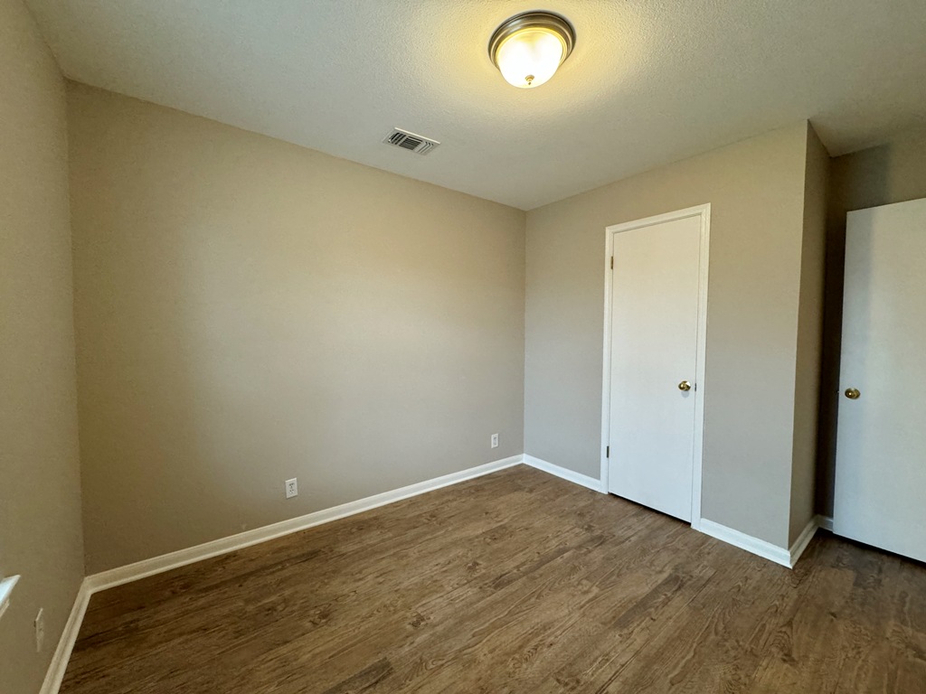 219 Crystal Knoll Boulevard Georgetown, TX 78626 - Photo 20 of 32 an empty room with wooden floor and windows