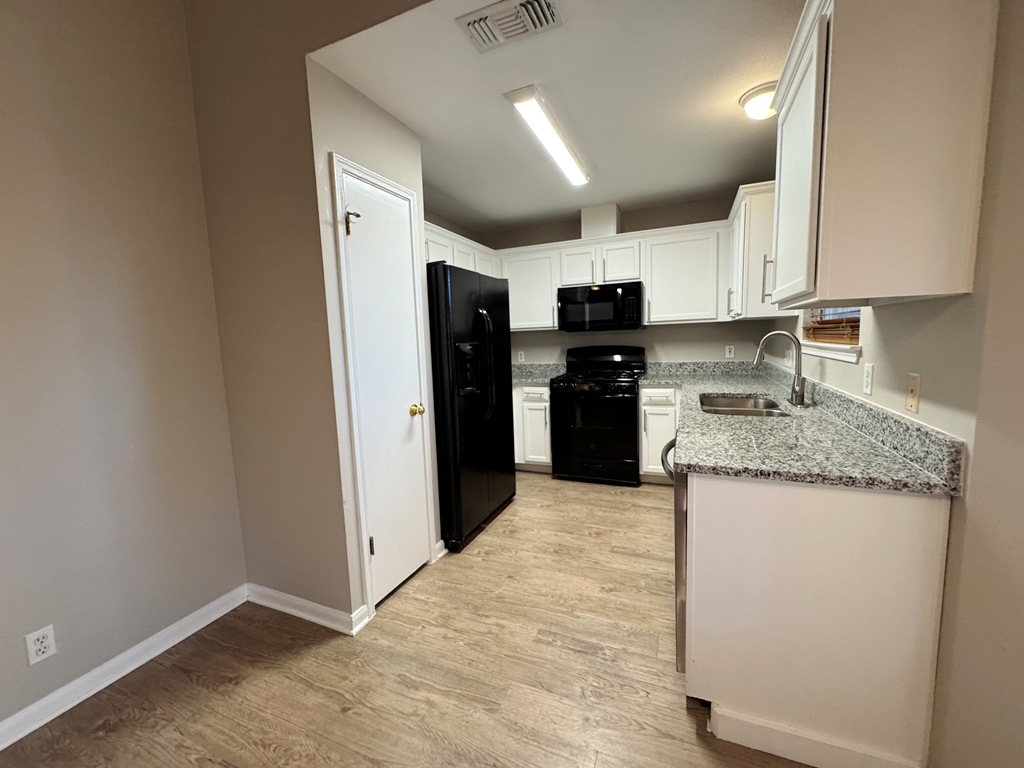 219 Crystal Knoll Boulevard Georgetown, TX 78626 - Photo 6 of 32 a kitchen with stainless steel appliances granite countertop a refrigerator a stove a sink and a microwave
