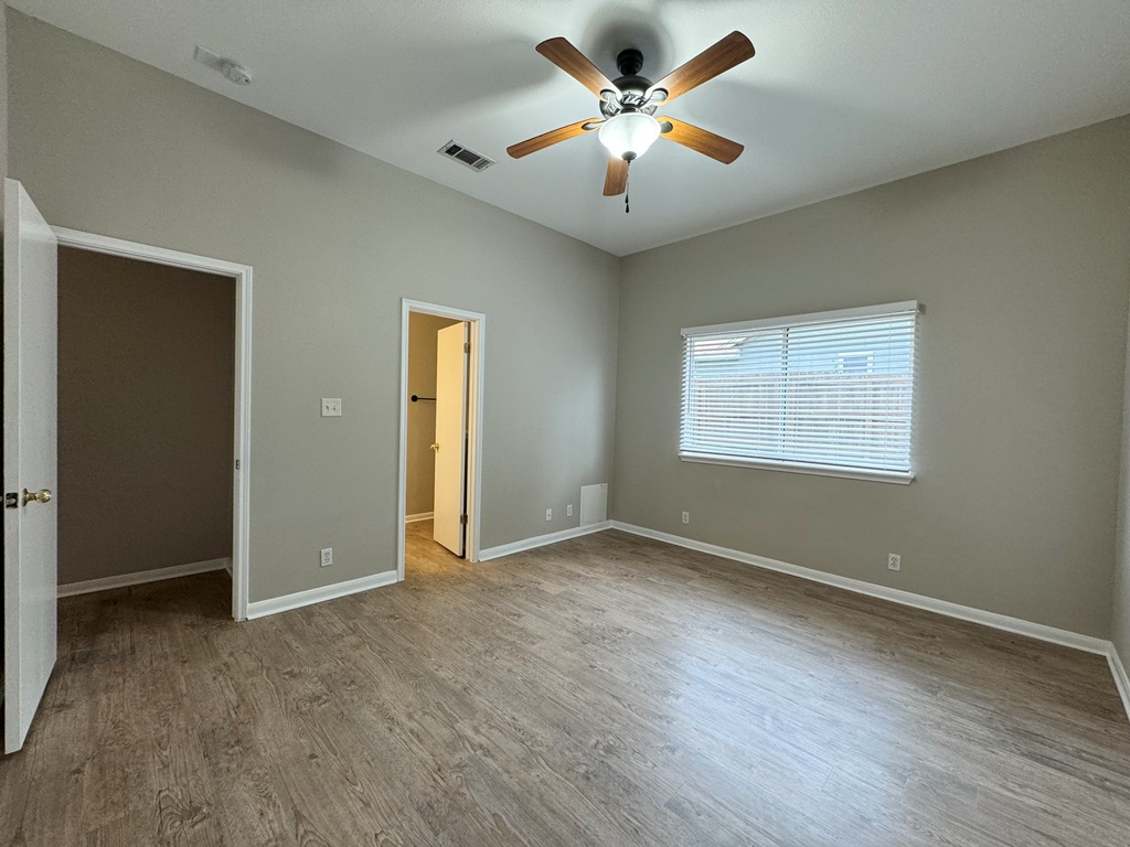 219 Crystal Knoll Boulevard Georgetown, TX 78626 - Photo 7 of 32 wooden floor in an empty room with a window