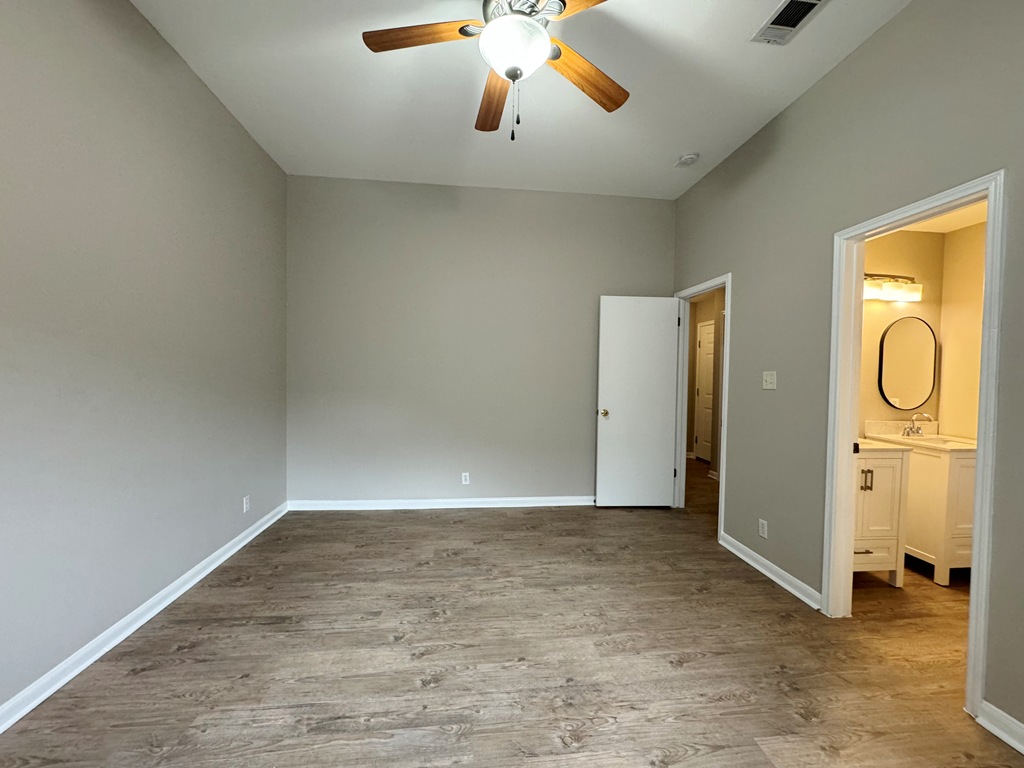 219 Crystal Knoll Boulevard Georgetown, TX 78626 - Photo 9 of 32 a view of an empty room with wooden floor and a window