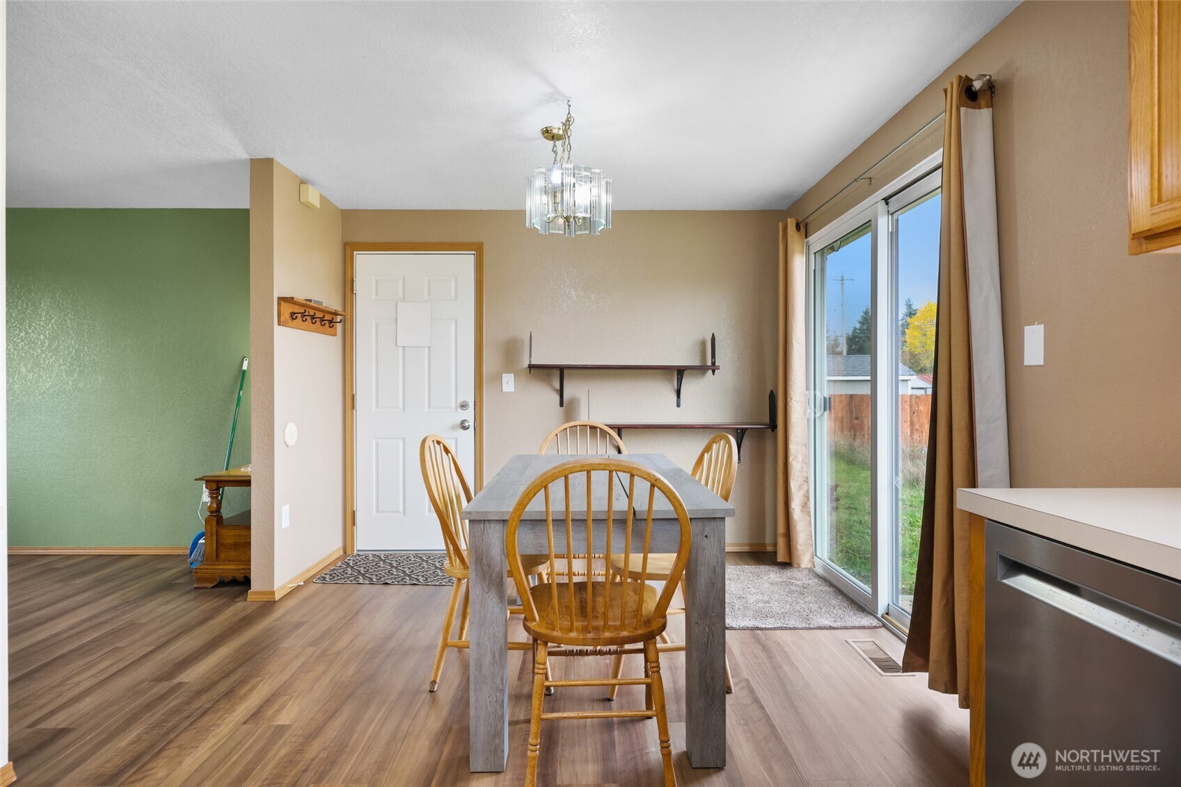 17932 Camus Drive Southwest Rochester, WA 98579 - Photo 9 of 28 a view of a dining room with furniture a chandelier and wooden floor