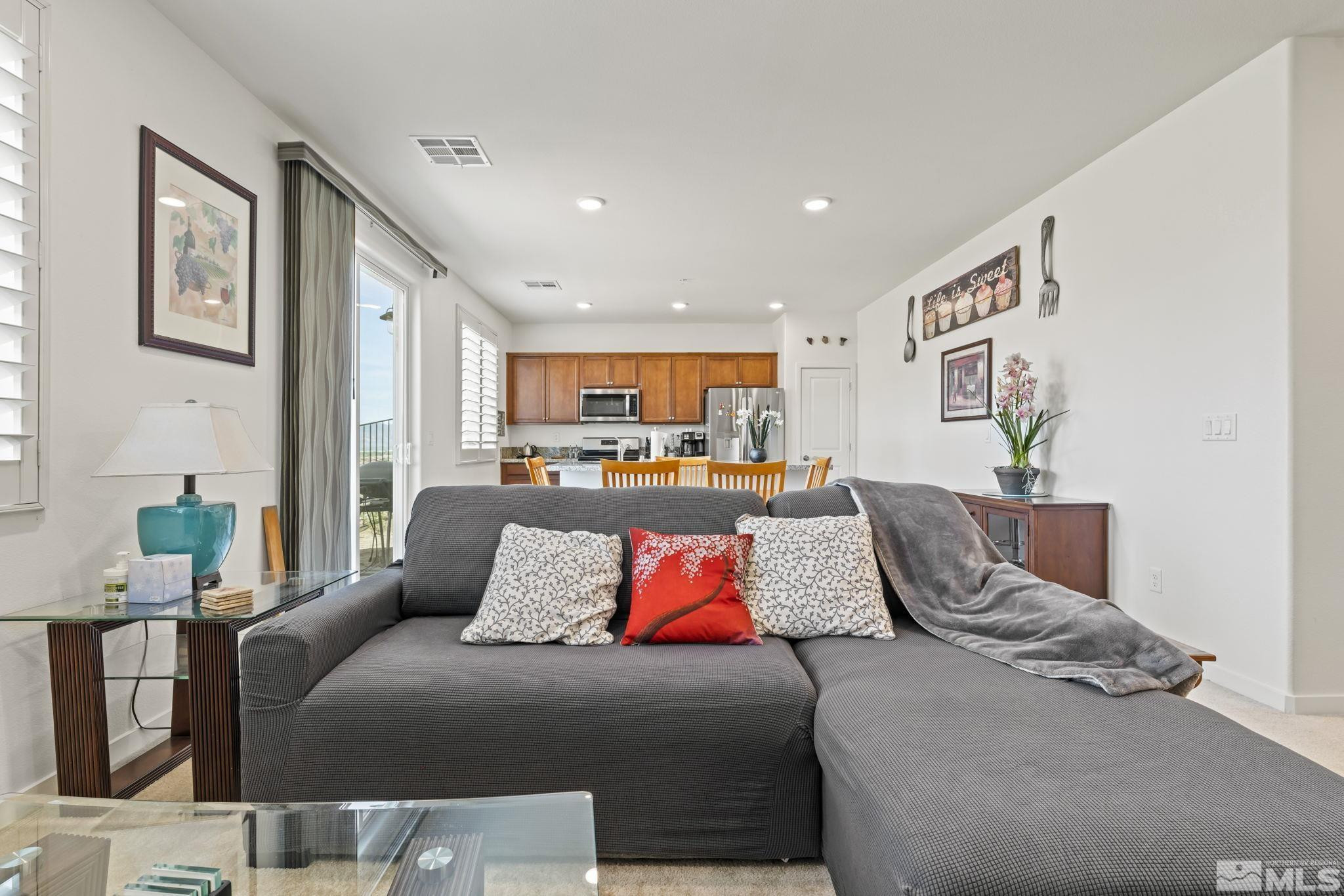 4928 Black Falcon Way Sun Valley, NV 89433 - Photo 11 of 32 a living room with furniture and kitchen view