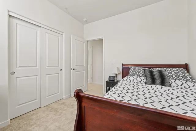 a bedroom with a large bed and a shower