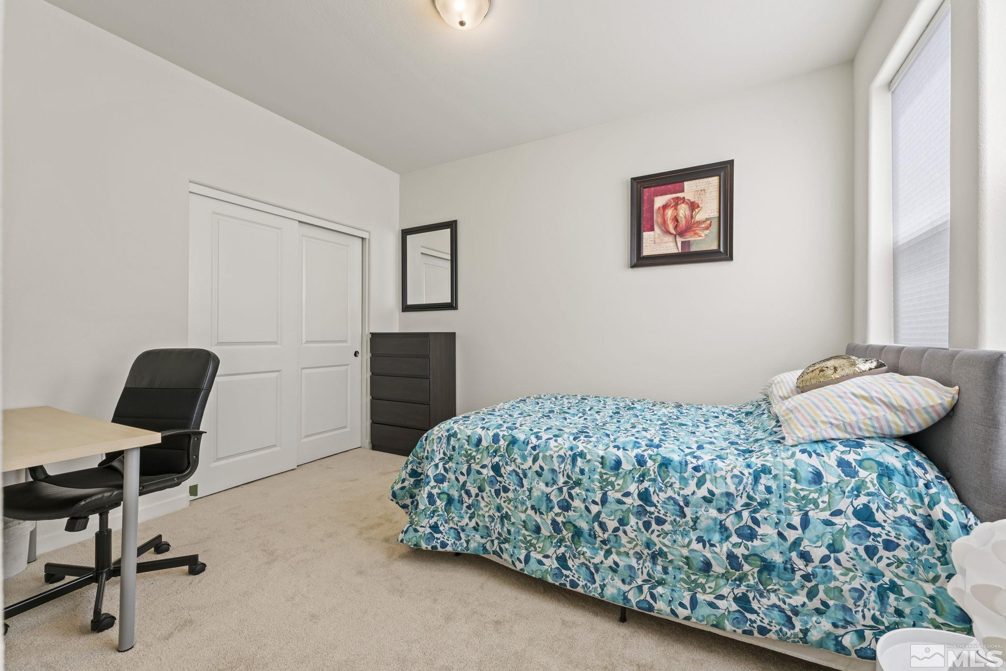 4928 Black Falcon Way Sun Valley, NV 89433 - Photo 20 of 32 a bedroom with a bed and a desk
