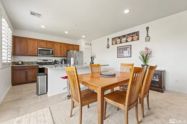 a dining room with furniture and a kitchen view